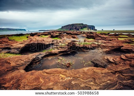 Sandy rocks with by magma formed by winds. Popular tourist attraction. Unusual and gorgeous scene. Location Sudurland, cape Dyrholaey, south coast of Iceland, Europe. Artistic picture. Beauty world.
