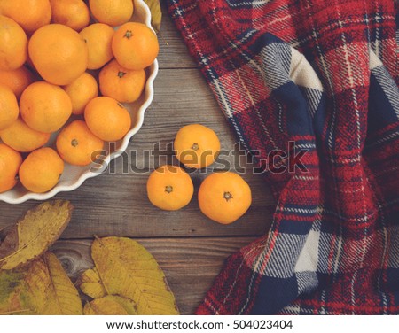 Flat lay view of fresh mandarines on wooden table and bowl - Autumn concept