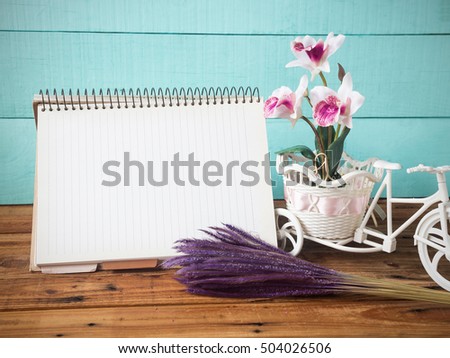 recycle paper notebook  on wooden table,vintage style,soft focus image