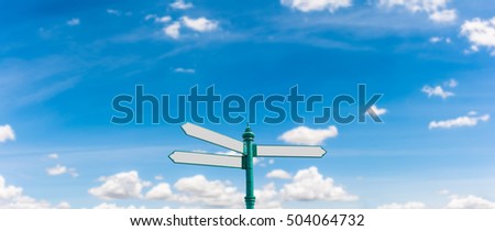 Three Direction Blank Road Sign on Blurry Blue Sky And White Clouds Panorama Background, Center Position