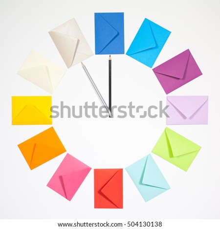 Twelve envelopes isolated on white background. Clock of colored envelopes for Christmas mailing.