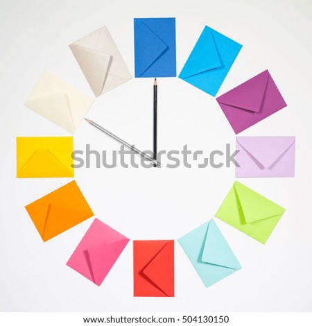 Twelve envelopes isolated on white background. Clock of colored envelopes for Christmas mailing.