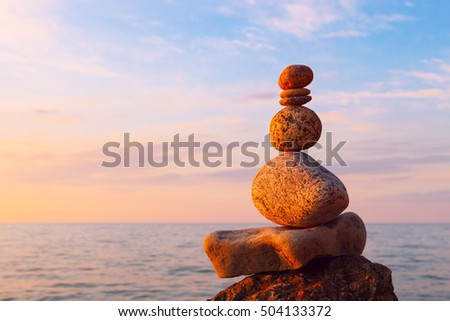 Concept of harmony and balance. Rock Zen at sunset. Balance and poise stones against the sea