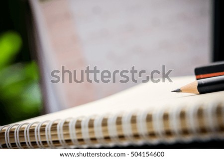 A pencil, Workspace work desktop business stylish modern space wood background, pencil and eraser on notebook on wooden table