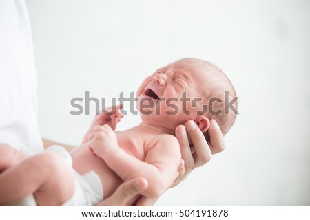 Portrait of a screaming newborn hold at hands, family, healthy birth concept photo, close up Royalty-Free Stock Photo #504191878