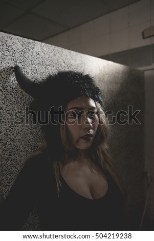 Scary girl in dark room with black hat,happy halloween