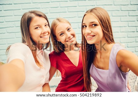 friendship, people, hen-party and fun concept - happy friends or teenage girls taking selfie