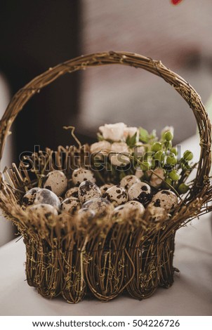 little quail eggs lying in a wooden basket