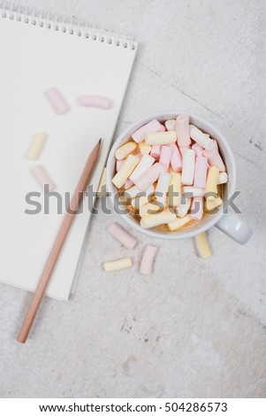 womans office table with coffee and marshmallows