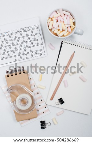 womans office table with coffee and marshmallows