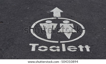 toilet sign on the road