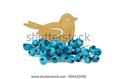Little wooden bird is handmade and frozen berries, isolation on a white background. Rustic decorations for Christmas.