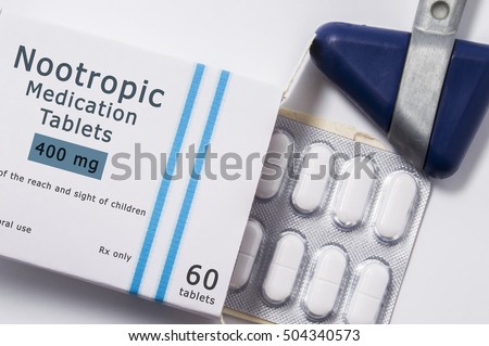 Nootropic drug. Neurological reflex hammer and packaging box of medication with name group of drug Nootropic with blister with pills on white background close up. ?oncept for treatment of migraine Royalty-Free Stock Photo #504340573