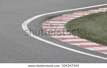 sleek asphalt and danger at the bend of the motorbike track, motoGP, desaturated