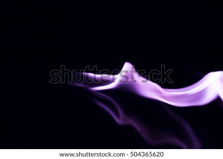 Purple fire flames on black background