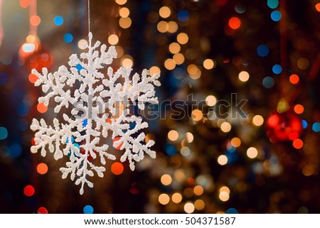 Snowflake decorations, bokeh background, out of focus lights, Christmas and Happy New Year defocused abstract background. Very shallow deep of field.