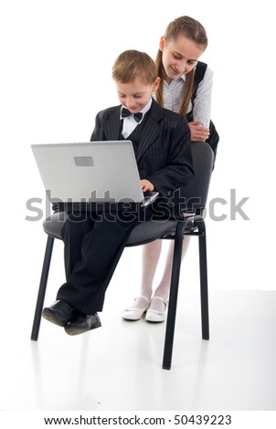 Schoolboy, Schoolgirl And Laptop.Studio Shoot Over White Background.