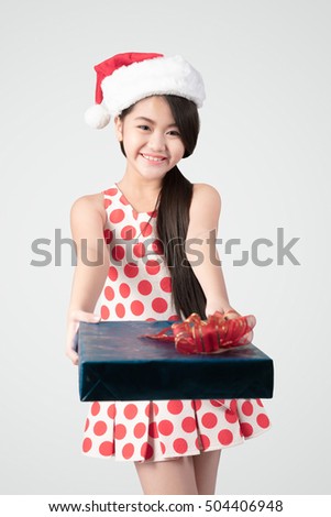 Happy young asian girl in christmas hat with presents. Merry Christmas and Happy New Year