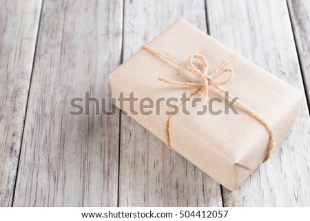 Cardboard box on a wooden background, Brown mail package parcel wrap delivery