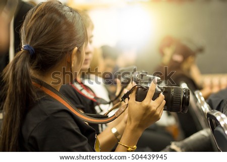 Education concept woman hand holding camera in workshop room