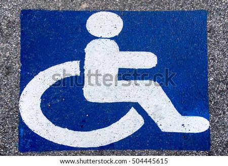 handicapped parking sign paint onto asphalt parking area