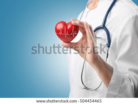 Cardiologist holding red heart with electrocardiogram. Cardiology concept. Royalty-Free Stock Photo #504454465