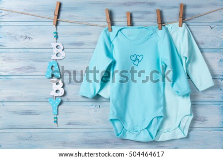 Baby clothes and word baby on a clothesline