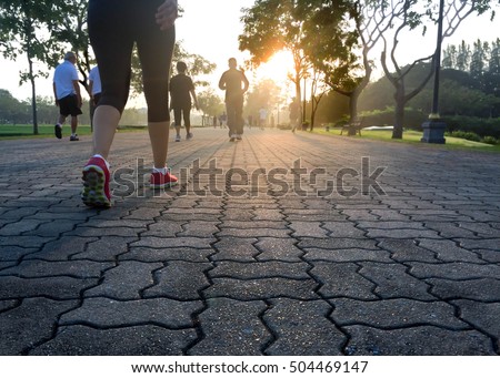 Group of people exercising in the park in sunrise morning well being concept Royalty-Free Stock Photo #504469147