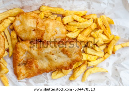 Close up fish and chips in cardboard takeaway, traditional English meal.