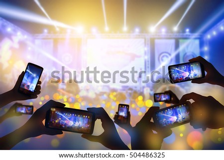 Silhouette of hands using smart phone to take pictures and videos at live concert  happy luxury party.