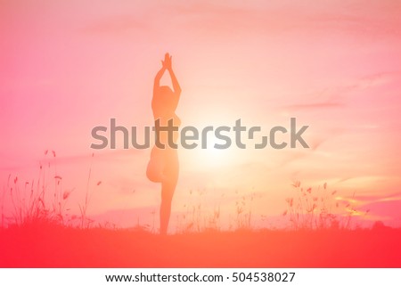 Silhouette picture of a woman plays yoga