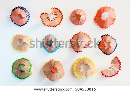 Color pencils shavings on white Royalty-Free Stock Photo #504550816