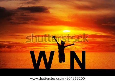Silhouette young woman jumping on the beach and WIN message, Win concept, celebrating businesswoman success and goals sport exercising and working out. Royalty-Free Stock Photo #504563200