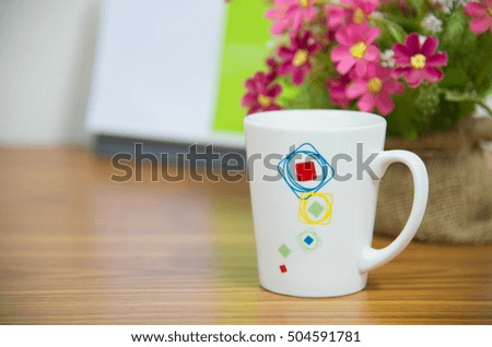 flowers with coffee cup on workspace.happy every time concept.