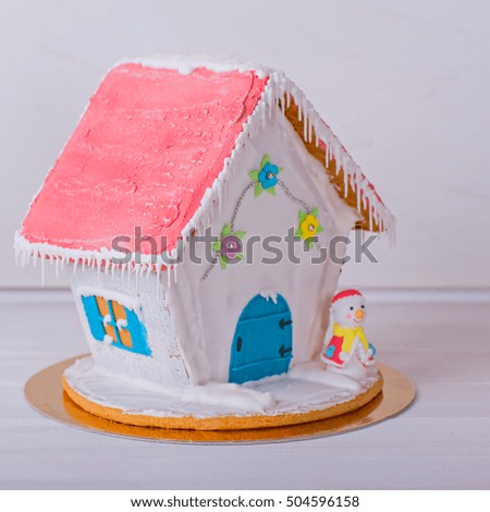 Homemade gingerbread house on a white background
