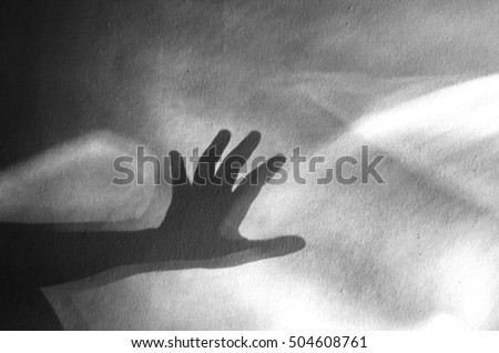 human hand shadow on vintage wall background