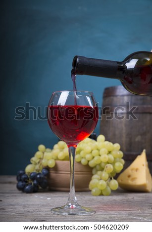 pouring red wine on background