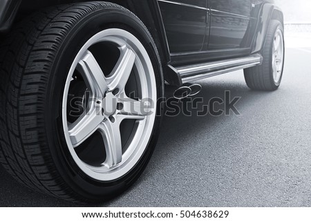Car wheels close up on a background of asphalt. Car tires. Car wheel close-up. for advertising (for advertising) 