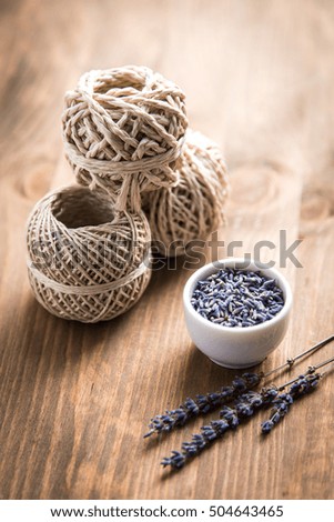 lavender flowers with spool of thread on a wooden background