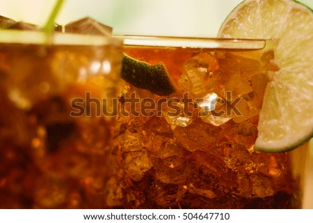 drink concept - cocktail with  cola ice cubes and lime
