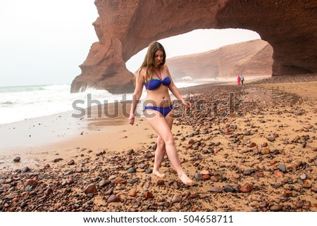 Girl, beach and sea in cloudy and foggy day