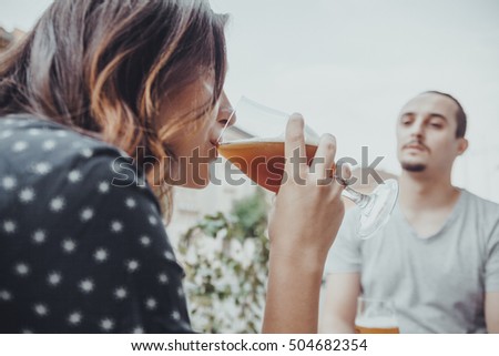 A Couple Drinking Beer Outside