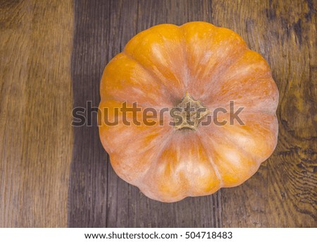 Orange pumpkins over wooden table. Autumn pumpkin on wooden board.