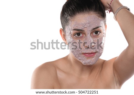 Young and beautiful woman with Purifying Mask on her face. On white background 