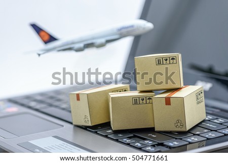 Mini cardboard boxes on a laptop with a plane flies behind. For several purposes or ideas about transportation, international freight, global shipping, overseas trade, regional  / local forwarding.  Royalty-Free Stock Photo #504771661