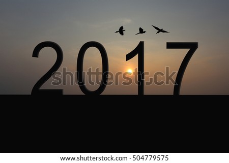Silhouette of number 2017 on the house roof and sunrise in twilight sky,concept of the New Year and Christmas.