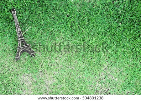Background template of Eiffel Tower model on the grass 