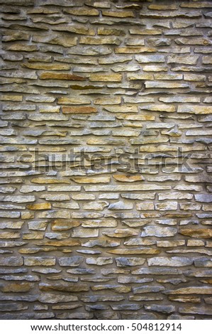 parti-coloured slate wall texture and background close-up