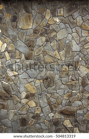 house wall decorated with a wild stone slate, sandstone close-up
