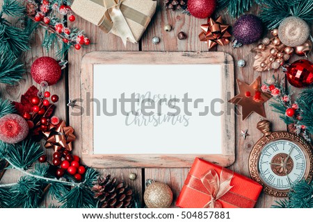 Christmas photo frame mock up template with decoration on wooden table. View from above